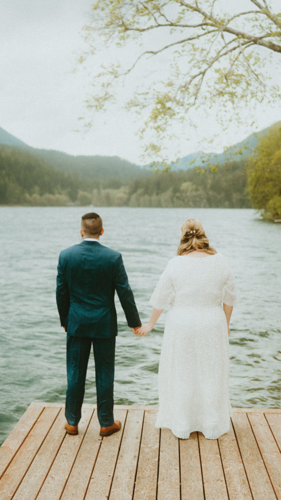 Landscape shot behind elopement couple in front of a lake in Oregon