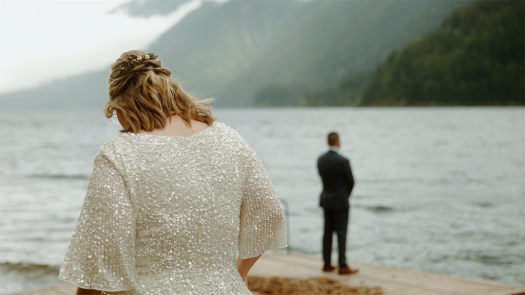 First look in front of lake in Oregon taken by Oregon Wedding Videographer, Alesia Films