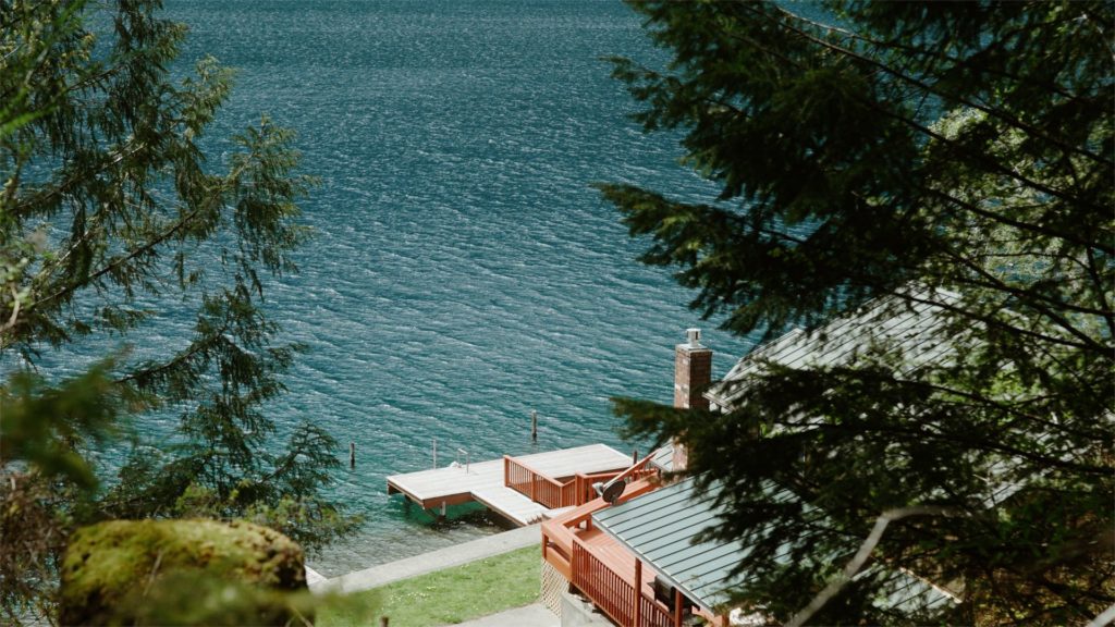 still of lake next to an AirBnb cabin in olympic national park forest filmed by adventure wedding videographer, Alesia Films