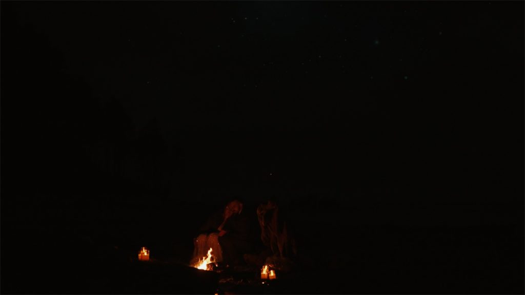 still of newylwed couple next to bonfire on beach coast in olympic national park oregon filmed by Oregon elopement videographer, Alesia Films