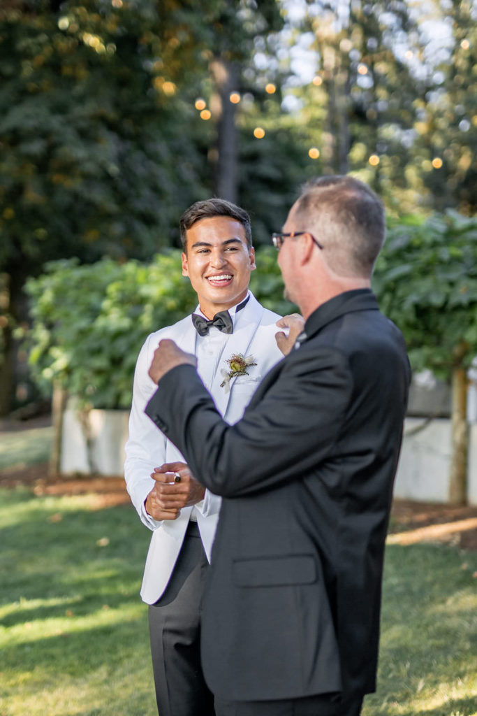 Groom and father at winery summer elopement