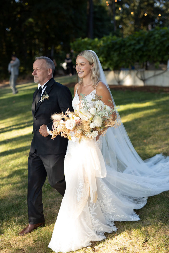Bride with father entrance to Domaine de Broglie elopement in Dayton, Oregon