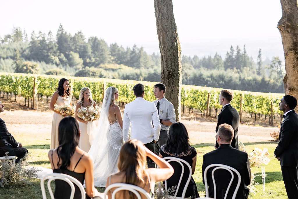 Bride and groom with pastor during elopement ceremony at Domaine de Broglie winery in Dayton, Oregon