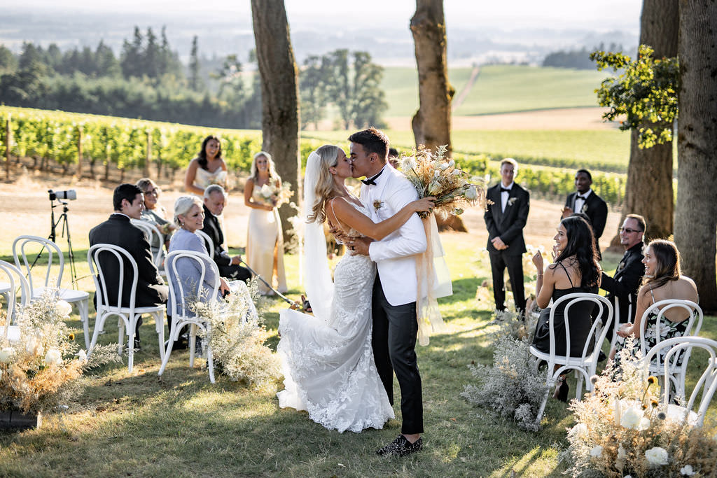 First kiss of newlyweds at Domaine de Broglie winery summer elopement in Dayton, Oregon
