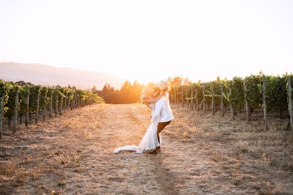 Golden hour portrait of newlyweds kissing at Domaine de Broglie winery summer elopement in Dayton, Oregon