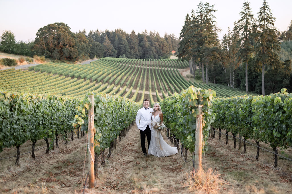 Portrait of newlyweds smiling at Domaine de Broglie vineyard for their winery summer elopement in Dayton, Oregon