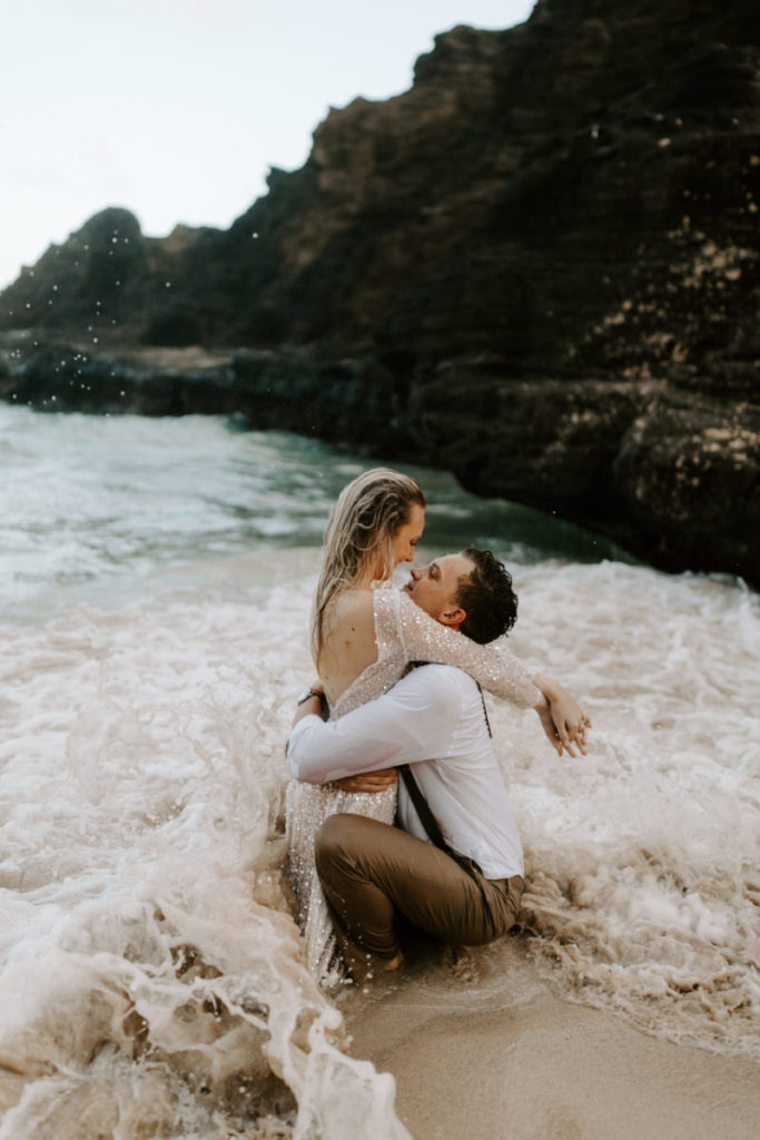 bride and groom in ocean