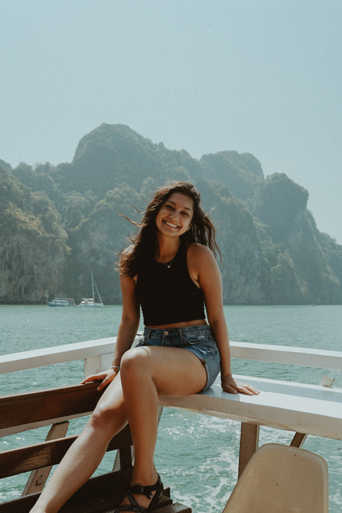 girl sitting on boat in thailand