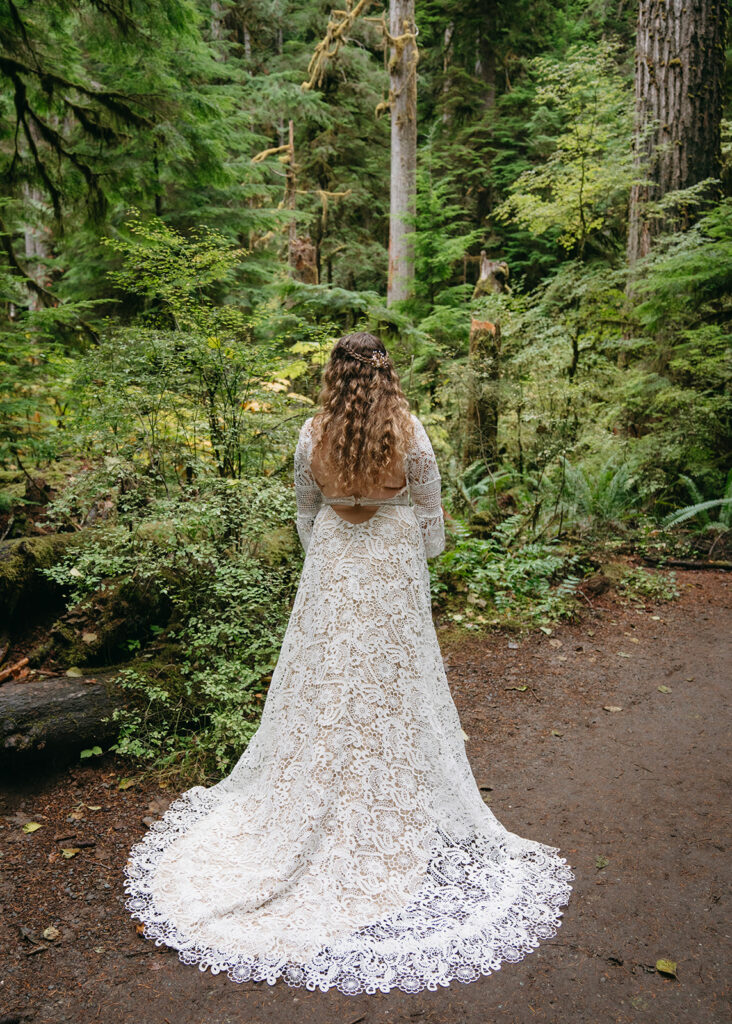 photo of bride with wedding dress in forest