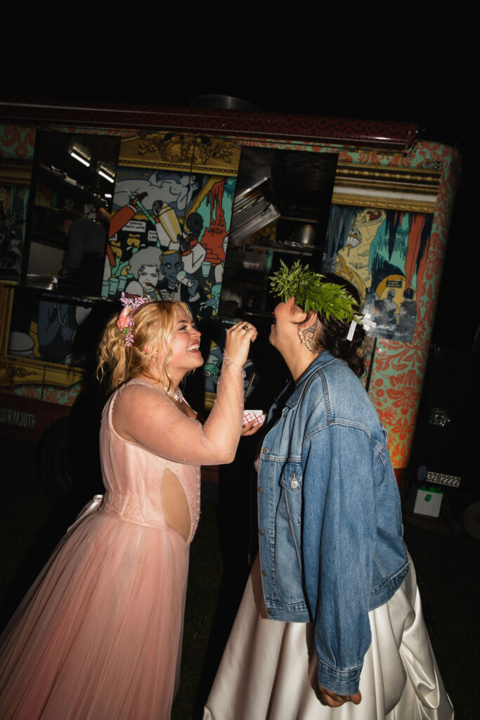 Fairytale brides sharing wedding cake at Orcas Island wedding reception