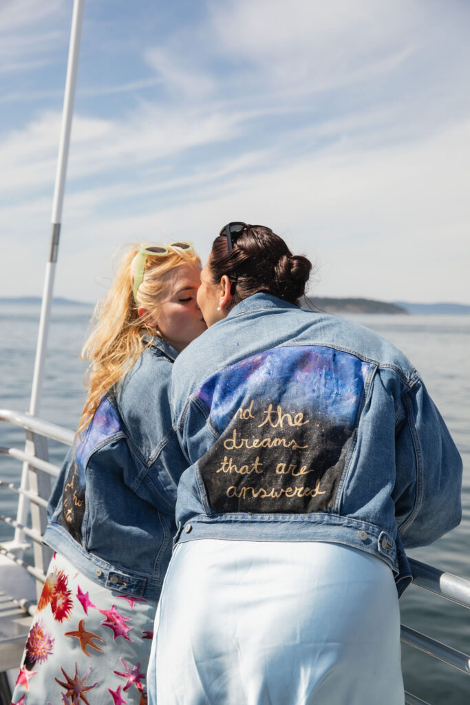 Brides share a kiss during pre-wedding San Juan Island whale-watching trip