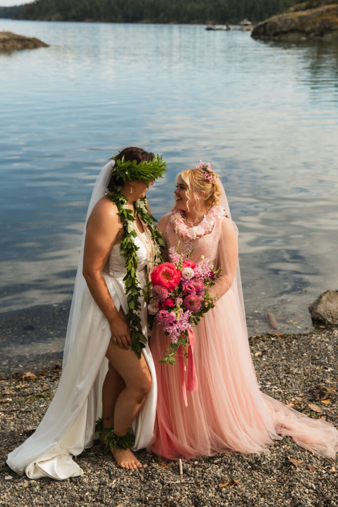 Bridal portrait of two brides standing on beach at Orcas Island wedding