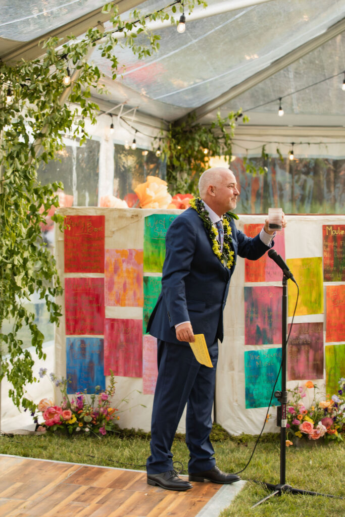 colorful fairytale orcas island wedding decor man giving speech