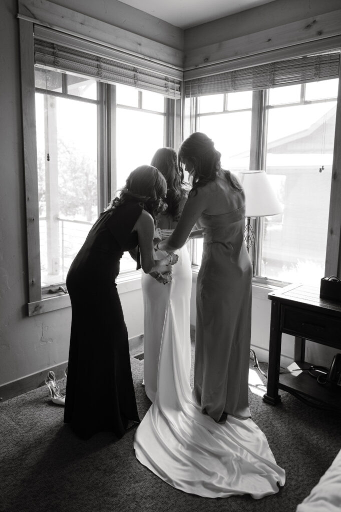 Bride putting on wedding gown at Brasada Ranch