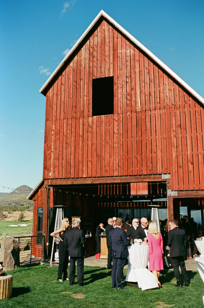 Brasada Ranch wedding cocktail hour beside red barn