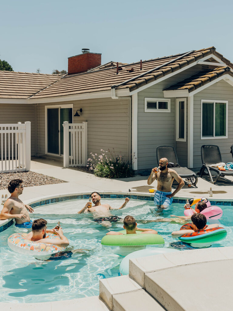 Groom and groomsmen relaxing in swimming pool before Callaway Vineyard & Winery wedding