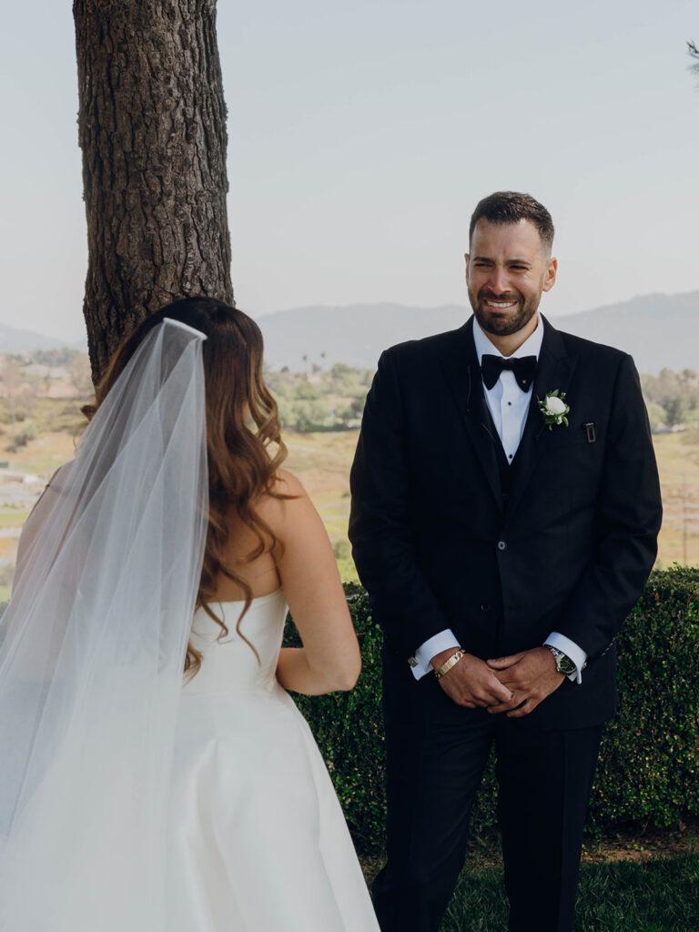 Groom looks tearfully at bride during Callaway Vineyard & Winery wedding first look