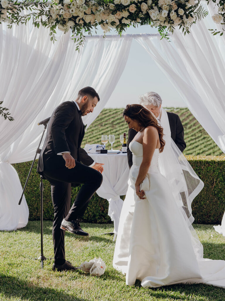 Groom breaking the glass during Callaway Vineyard & Winery wedding ceremony