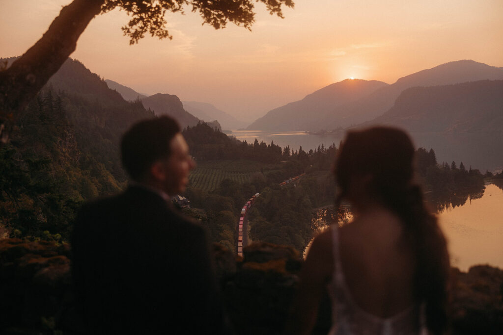 Sunset silhouette shot of bride and groom overlooking the Hood River valley