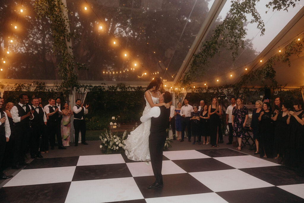 Groom lifting bride during first dance at romantic Griffin House wedding