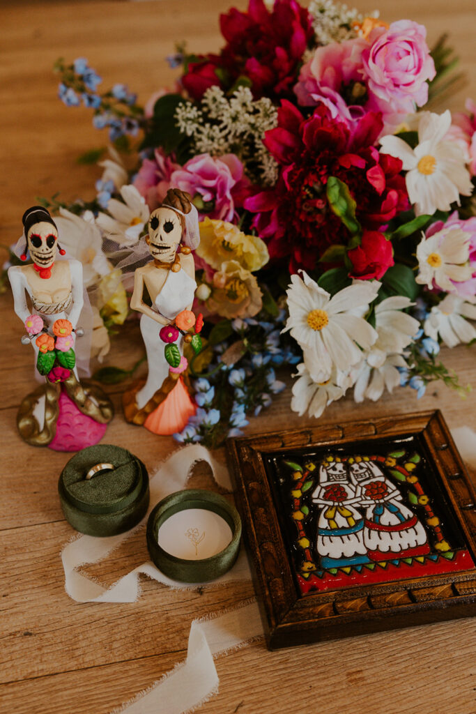 Personal details featuring two dia de los muertos statues of the brides