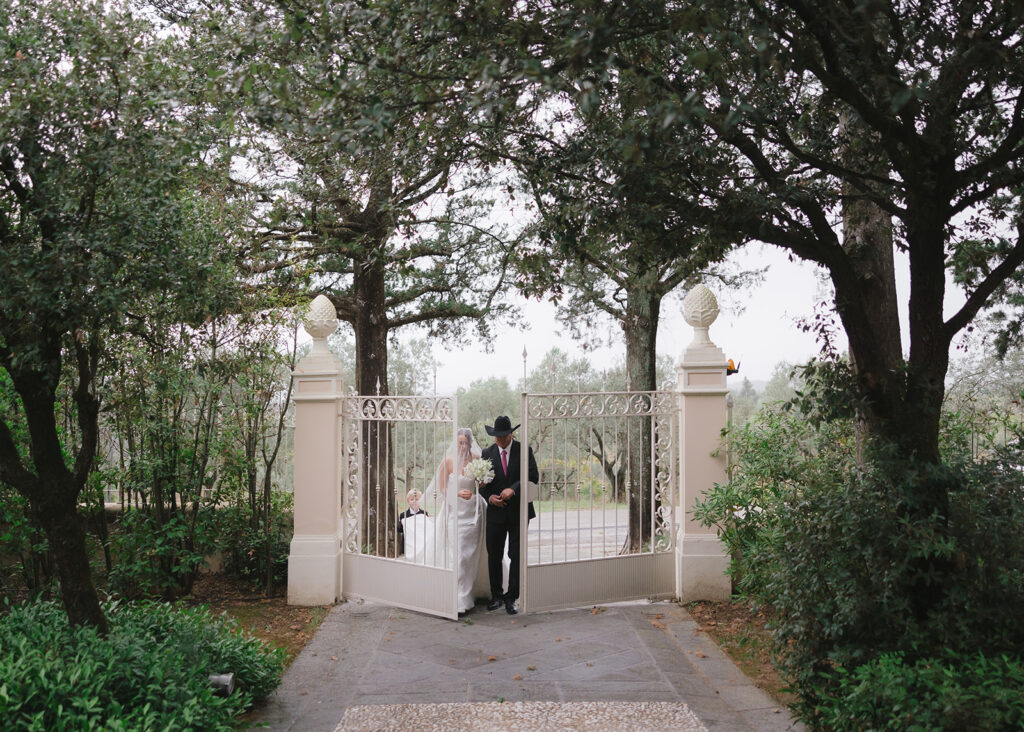 Father of the bride walking bride down the aisle for intimate Italian wedding