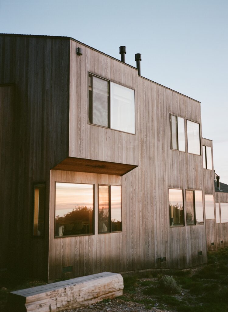 Lodge building exterior with sunset reflected in the windows.