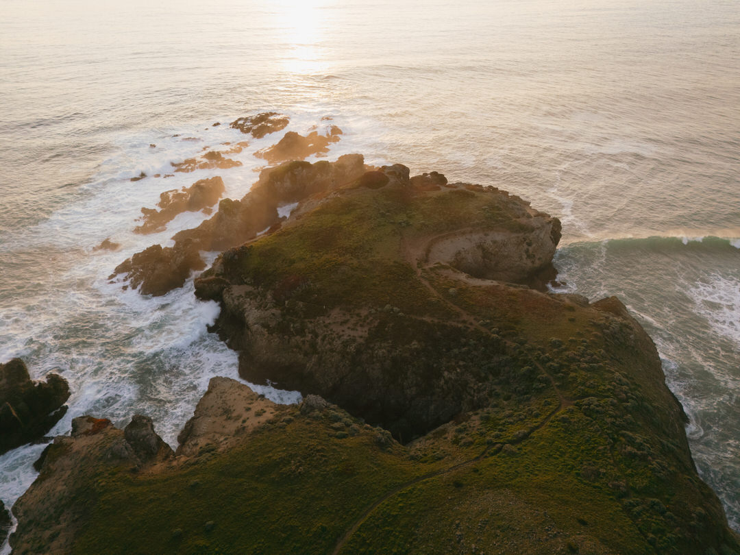 Rocky cliffs and ocean shoreline at sunset during Sea Ranch Lodge wedding.