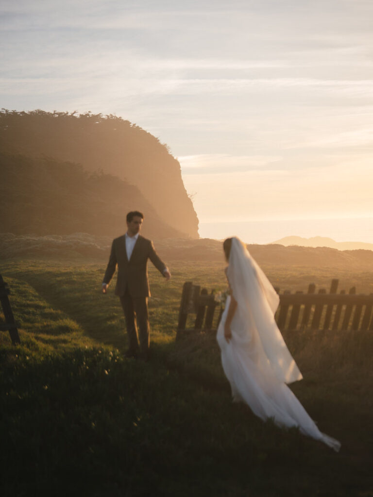 Sunset portraits with bride and groom framed by rustic fencing at Sea Ranch Lodge wedding