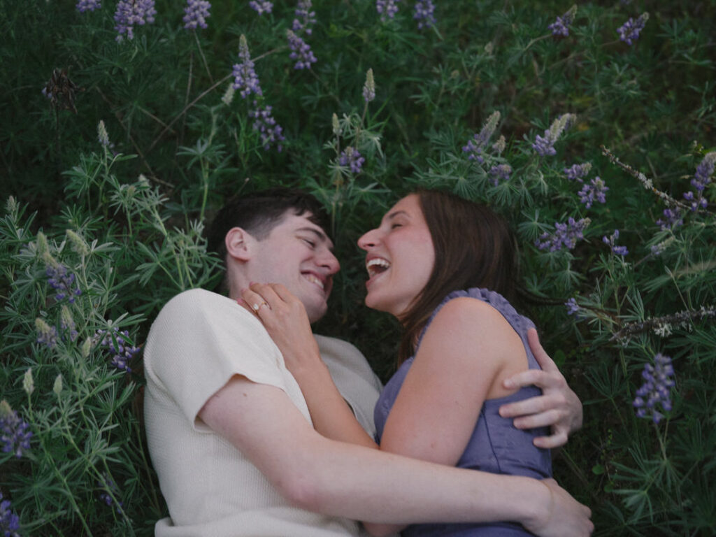 Joyful moment lying together in the wildflower-filled Columbia Gorge.